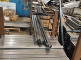 several pieces of metal are stacked on pallets in a warehouse
