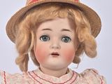 a close up of a doll with a hat on
