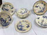 several blue and white china plates and bowls on a table