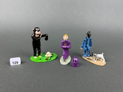 three figurines of a man in a purple suit and a man in a blue suit