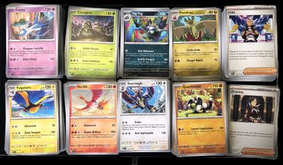 a lot of different pokemon cards on the table
