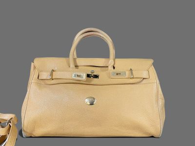 beige leather handbag and shoes on grey background with grey background