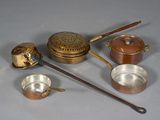 many different types of pots and pans sitting on a table