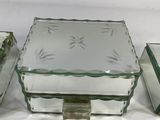 three glass boxes with lids are sitting on a white surface