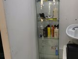 a bathroom with a sink and a glass cabinet in it