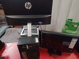a desk with a computer and a laptop on it