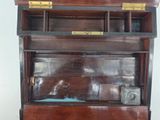 an old wooden cabinet with a glass door on it