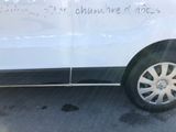 a white van with writing on the side parked in a parking lot
