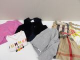 a lot of clothes that are on a white table