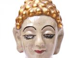 a figurine of a buddha with a red and blue dress