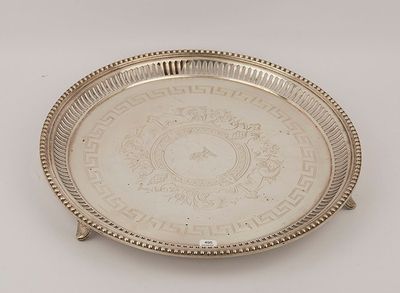 an antique silver plate with a design on the rim
