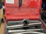 a red tool case with tools in it on a table