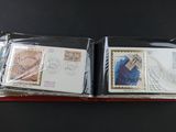 two envelopes with stamps on them sitting on a table