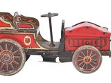 a red and black toy car on a white background