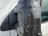 a car with a bag on the side of it ' s side mirror