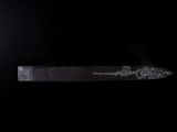 a knife that is sitting on a black surface