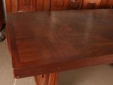 a large wooden table that is in the middle of a room