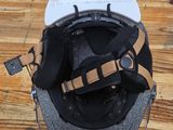 a helmet on a wooden table with a cord attached to it