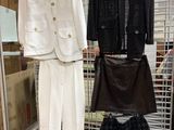 two pieces of clothing hanging on a rack in a store