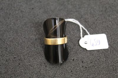 a black and gold ring with a tag on it