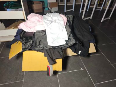a pile of clothes sitting on the floor in a room