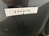 someone is measuring the height of a car with a ruler