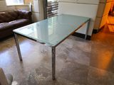 a glass table in the middle of a living room