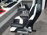 a black and white office chair in front of a computer desk