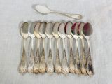 six spoons and a spoon with a spoon rest on a table