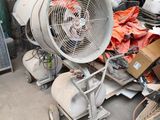 a large fan sitting on top of a cart in a garage