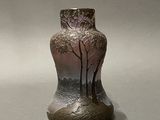 a vase that has a tree on it on a table