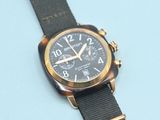 an image of a close up of a watch on a blue surface