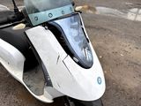 a scooter that is parked on the side of the road