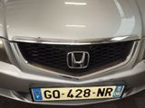 the front of a silver car with a number plate on it