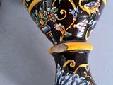 a black and yellow vase sitting on a table