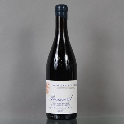 a bottle of wine sitting on top of a glass table