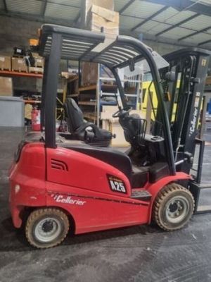 a red fork truck that is parked in a warehouse