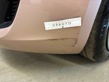 a pink car with a sticker on it ' s bumper