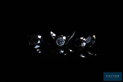 a group of three black diamonds on a black background