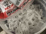 a plastic container filled with shredded paper on the floor