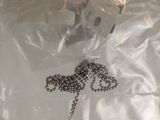 a necklace that is laying on top of a plastic bag