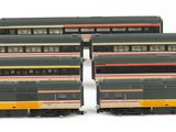 four model trains are lined up in a row on a white surface