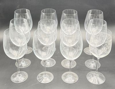 six empty wine glasses are lined up on a table