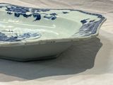 a blue and white bowl sitting on a white table