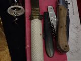 a knife, knife sharper, and a knife on a pink box