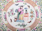 a plate with a woman and a lizard on it