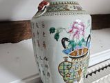 a vase sitting on top of a radiator in a room