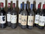 several bottles of wine are lined up in a row
