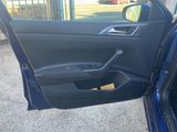 the door of a blue car with the driver ' s side door open