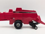 a red toy tractor with a trailer attached to it